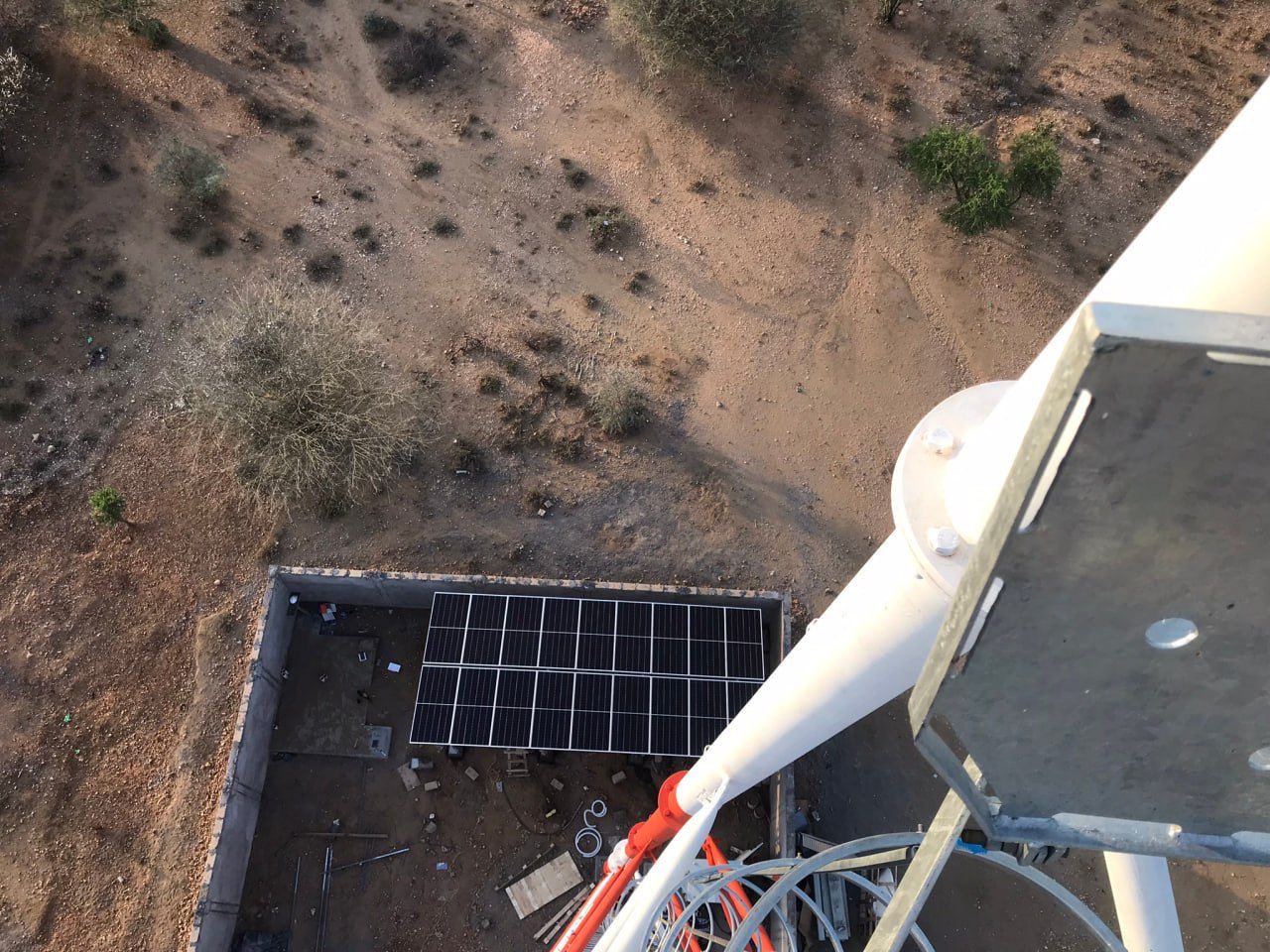Solar panels installed at the base of a telecom tower