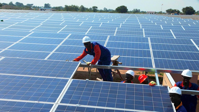 Installation crew servicing a solar array